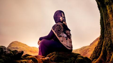 woman looking over mountains