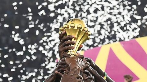 The Africa Cup of Nations trophy being held aloft