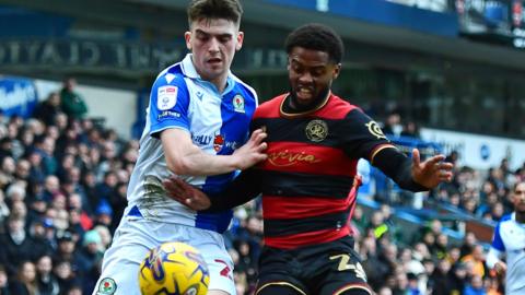 Blackburn Rovers' Andy Moran vies for possession with Queens Park Rangers' Kenneth Paal