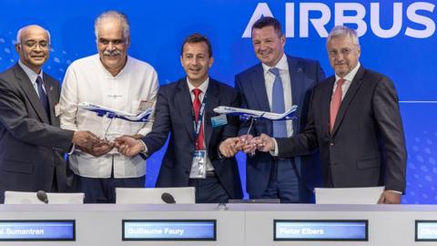The co-founder of InterGlobe Aviation and the CEOs of Airbus and IndiGo after signing the record order at the Paris Airshow