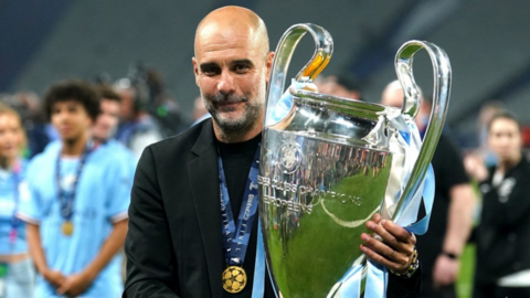 Pep Guardiola holding the Champions League Trophy