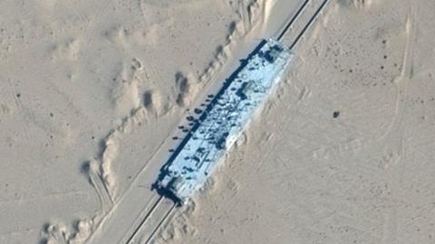 A satellite image shows a mock-up US military ship in the desert in Xinjiang, north-western China