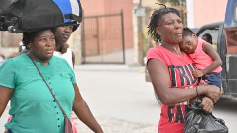 People flee gang violence in the Petion-ville neighborhood of Port-au-Prince on January 30, 2024.