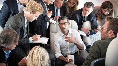 Prime Minister Rishi Sunak holds a huddle with political journalists on board a government plane as he heads to Japan to attend the G7 summit in Hiroshima