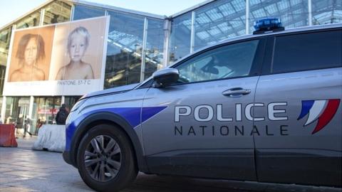 A police car sits parked outside Gare du Nord train station after police shot dead a man wielding a knife in Paris, France, on 14 February 2022
