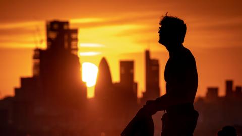 View of the sun and skyline from the top of Greenwich Park as the UK's heatwave continues, 13 July 2022