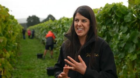 A woman standing in front of vines in Shropshire