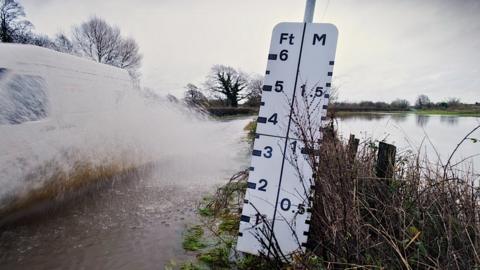 Water measurement board on the side of the road