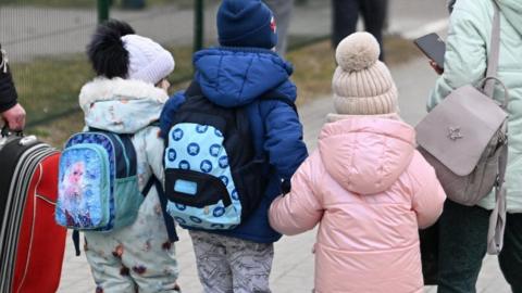 Three children arriving at a border