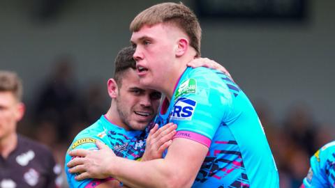 Wigan’s Harvie Hill celebrates a try with team-mate Tom Forber