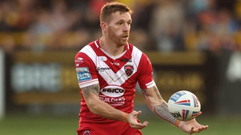 Salford Red Devils' Marc Sneyd passing the ball