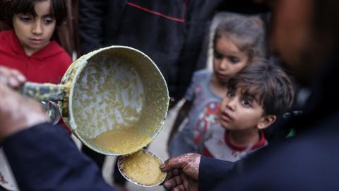 Children wait for food distribution in Gaza