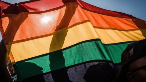 People take part in a Pride parade