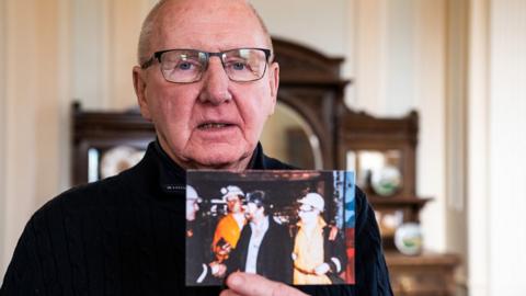 Bob Young holds a photograph of himself with Arthur Scargill