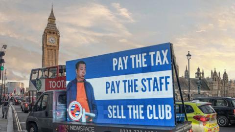 A screen on a lorry in front of Big Ben protesting against Reading owner, Dai Yongge