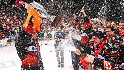 Shefield Steelers captain Robert Dowd celebrates after the Challenge Cup win by lifting the trophy and being sprayed by champagne