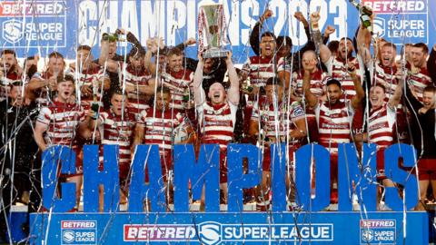 Wigan players celebrate their 2023 Super League title success