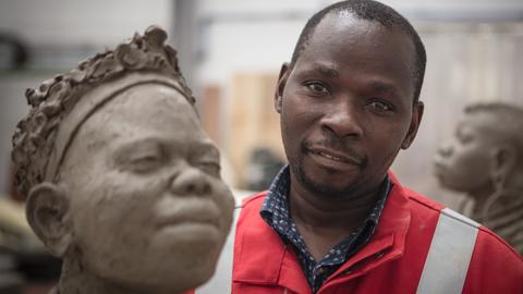 Peter Oloya with one of his works at Pangolin Editions foundry, 2019