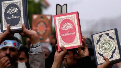 Yemenis hold up copies of the Koran during a protest against the desecration and burning of the Koran, in Sana'a, Yemen. Photo: 24 July 2023