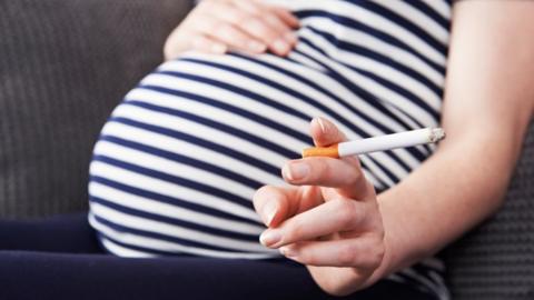 Pregnant woman with cigarette