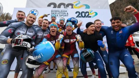 Britain's four-man bobsleigh team, right, celebrate with fellow medallists after finishing second at the World Championships in St Moritz, Switzerland