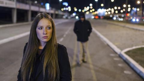 Woman being followed by a man down the street (file photo)