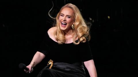 Adele smiles as she performs during the first night of her residency in Las Vegas