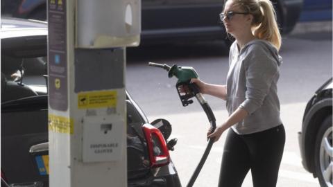 Woman filling car