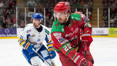 Riley Brandt skates with the puck for the Cardiff Devils