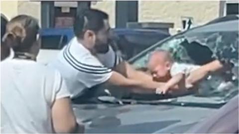 Man pulls baby out of car through smashed windscreen