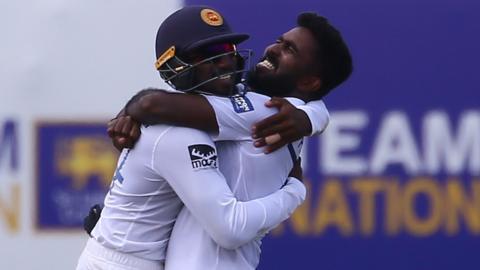 Asitha Fernando (right) celebrates after dismissing Lorcan Tucker on Friday