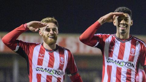 Lincoln City's Reeco Hackett, right, celebrates scoring his side's second goal with team-mate Ted Bishop