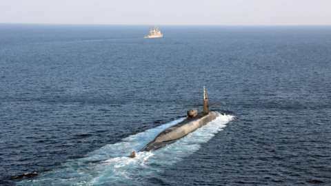 The guided-missile submarine USS Georgia transits the Strait of Hormuz with the guided-missile cruisers USS Port Royal and USS Philippine Sea