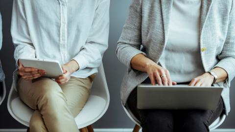 People on tablets and laptops in chairs