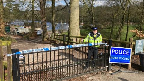 Lake cordoned off with police officer