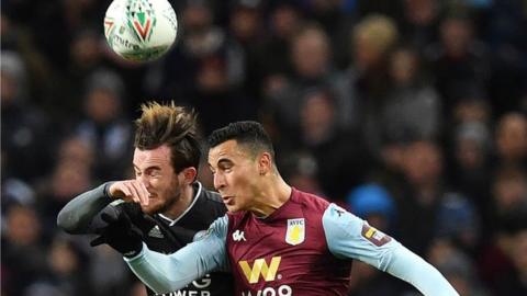 Leicester City's English defender Ben Chilwell (L) vies in the air to header the ball with Aston Villa's Dutch striker Anwar El Ghazi during the English League Cup semi-final second leg football match between Aston Villa and Leicester City at Villa Park in Birmingham, central England on January 28, 2020.