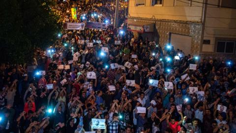 Demonstrators hold pictures of Nasser Zafzafi during a demonstration in the northern city of al-Hoceima on May 30, 2017