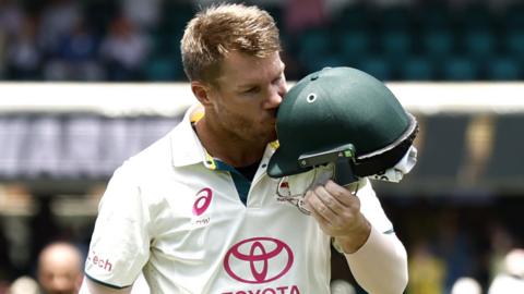 David Warner kisses his Australia helmet as he leaves the pitch during his last Test match