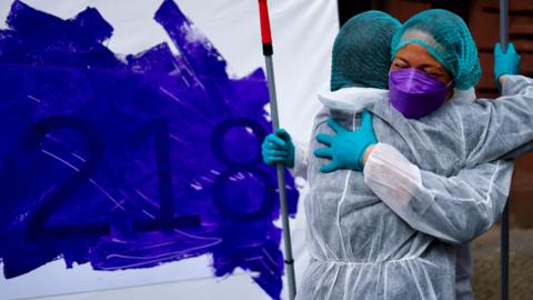 Activists symbolically cross out paragraph 218 abortion from the penal code with the color purple during a flash mob in Berlin, Germany, 15 April 2024