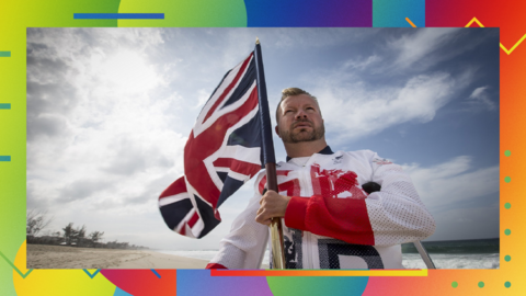 A photo of Paralympic champion Lee Pearson holding a Union Jack flag on the multi-coloured, patterned BBC Sport LGBT+ History Month background