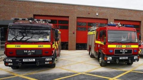 two fire engines outside a fire station