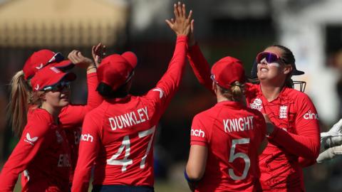 England's women celebrate a wicket v Ireland