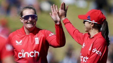 England's Sophie Ecclestone and Maia Bouchier high-five after taking a wicket v New Zealand
