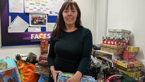 Michaela Martindale, Faces chief executive officer, with donated presents