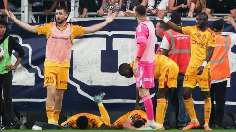 Rodez midfielder Lucas Buades lies on the pitch after being shoved to the ground against Bordeaux