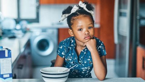 Little girl with cereal bowl (stock image)