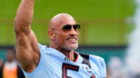 Dwayne Johnson on the field before the opening game of the 2023 XFL season