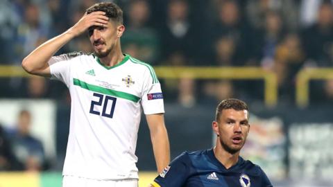 Northern Ireland's Craig Cathcart and Bosnia-Herzegovina's Edin Dzeko during the Nations League game in Sarajevo 13 months ago