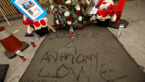 Justice 4 Anthony Lowe scratched onto fresh concrete at a memorial for Anthony Lowe Jr in Huntington Park, California