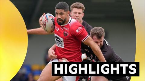 A Salford player is tackled during the game with London Broncos